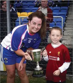  ??  ?? St Pat’s captain Liz Malone receives the cup from Cian Murphy.