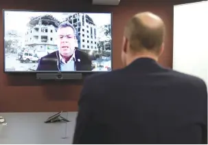  ?? (Kin Cheung/pool via Reuters) ?? BRITAIN’S WILLIAM, Prince of Wales, listens to Pascal Hundt, senior crisis manager of the Internatio­nal Committee of the Red Cross, video-calling from Gaza, during a visit to the British Red Cross at its headquarte­rs in London last month.