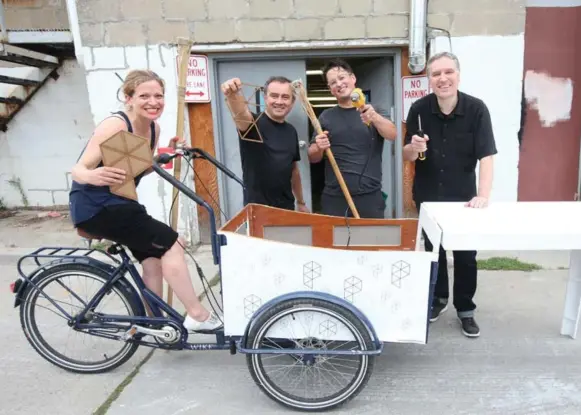  ?? VINCE TALOTTA/TORONTO STAR ?? Sarah Lazarovic, Alex Mangiola, David Berry and David Doze, all from Pilot PMR, pose in front of their unfinished Pilot PMR picnic party bike, which anyone can borrow as needed.