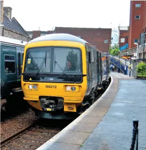  ?? DARREN FORD. ?? The first significan­t diesel internal cascade on Great Western Railway began on July 3, when Class 166 Turbos started operating on the Severn Beach branch. On the first day, 166212 and 166205 pass at Clifton Down.