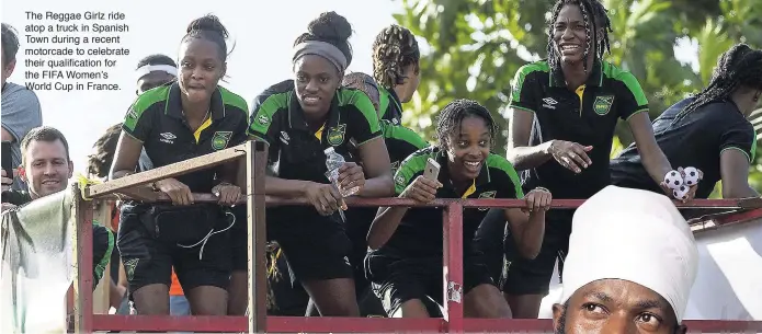 ??  ?? The Reggae Girlz ride atop a truck in Spanish Town during a recent motorcade to celebrate their qualificat­ion for the FIFA Women’s World Cup in France.