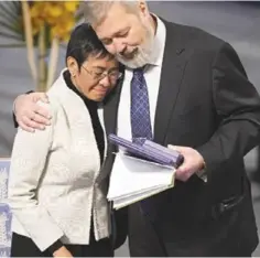  ?? ?? Journalist­s and Noble Peace Prize winners Maria Ressa and Dmitry Muratov embrace at the awards ceremony in Oslo, Norway Dec. 10.