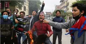  ??  ?? Nepalese students shout slogans during a May 11 protest in Kathmandu against the Indian government inaugurati­ng a new road through a disputed territory between India and Nepal. — AP