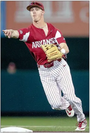  ?? AP/Austin American-Statesman/NICK WAGNER ?? Arkansas sophomore shortstop Casey Martin throws to first during the No. 9 Razorbacks’ 7-6 loss to No. 15 Texas on Wednesday night at Disch-Falk Field in Austin, Texas. Arkansas pitchers had 14 bases on balls and hit four batters as the Longhorns ended the Hogs’ seven-game winning streak.