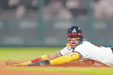  ?? AP PHOTO/JOHN BAZEMORE ?? Atlanta Braves' Ronald Acuna Jr., steals second base April 28 in the seventh inning of a baseball game against the Chicago Cubs in Atlanta.