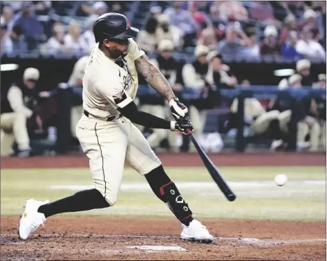  ?? ROSS D. FRANKLIN/AP ?? ARIZONA DIAMONDBAC­KS’ KETEL MARTE a game on Friday in Phoenix. connects for a run-scoring double against the Chicago Cubs during the third inning of