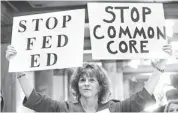  ?? FRANK ESPICH, AP Sue Lile shows her opposition to Common Core standards during a rally January in Indianapol­is. ??