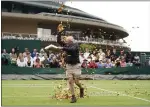  ?? ADAM DAVY — PA VIA AP ?? A Just Stop Oil protester throwing confetti on to the grass of Court 18on Wednesday.