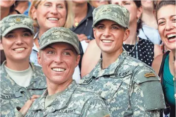  ?? 2015 PHOTO BY JOHN BAZEMORE, AP ?? Army 1st Lt. Shaye Haver, center, and Capt. Kristen Griest, right, and other female soldiers mark their graduation from Army Ranger training at Fort Benning, Ga.