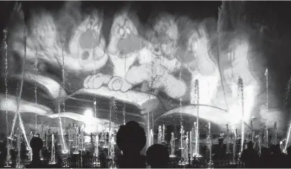  ?? Los Angeles Times file photo ?? An image from “Snow White and the Seven Dwarfs” is projected on spraying water in 2015 at Disney California Adventure. Walt Disney Co. has been approved for a patent to project 3D images on objects, creating an immersive experience for individual guests.