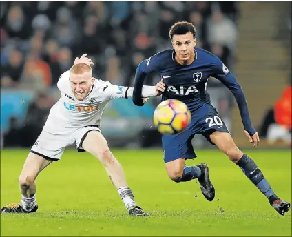  ?? Picture: REUTERS ?? TOUGH GAME: Swansea City’s Oliver McBurnie, left, in action against Tottenham’s Dele Alli during their Premier League match at Liberty Stadium, Swansea on Tuesday