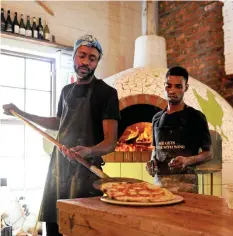  ?? | DAVID RITCHIE African News Agency(ANA) ?? MASSIMO’S at the Oakhurst Farm Park in Hout Bay has been named best pizzeria in Africa by “50 Top Pizza”. Pictured are employees Station Marechal and Shephard Gideon.