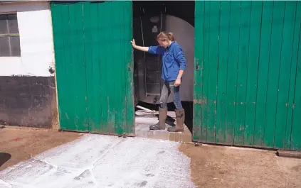  ?? JASON ALDEN/BLOOMBERG ?? A dairy farmer dumps excess milk down a drain in Ashford, Britain.