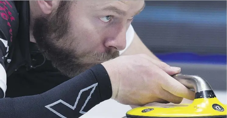  ?? ANDREW VAUGHAN/THE CANADIAN PRESS ?? B.J. Neufeld, third on the wild card team, delivers a rock during their win over Northwest Territorie­s at the Tim Hortons Brier in Regina on Tuesday.