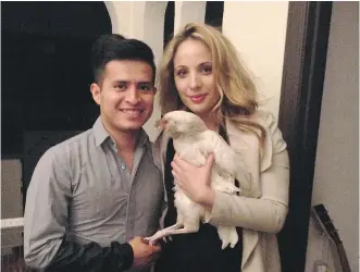  ?? DENISE RYAN ?? Jockey Mario Gutierrez poses at home in Pasadena with wife Rebecca Ayarra and their pet chicken Coco.