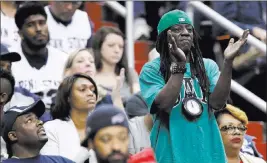  ?? ALEX BRANDON/ THE ASSOCIATED PRESS ?? Rapper Flavor Flav cheers for his cousin, Penn State’s Shep Garner, during the Nittany Lions’ 76-67 overtime win over Nebraska in the Big Ten tournament on Wednesday.