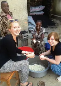  ?? Foto: privat ?? Julia Hartmann (links) und Alice Wagner im Kreise ihrer „neuen“Familie in Tansania. Was aussieht wie Knödelteig, wird zu Brot. Gebacken auf Steinen am Feuer ist es täg liche Nahrung für die Bewohner des „Olive Branch for Children’“.