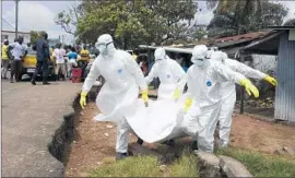  ?? Pascal Guyot AFP/ Getty Images ?? workers carry away the body of a suspected Ebola victim in Monrovia, the capital of Liberia. Ebola has killed more than 3,400 people inWest Africa.