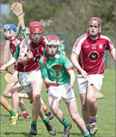  ??  ?? Jack Higgins of Gorey Community School breaks away from F.C.J. (Bunclody) duo Darragh Farrell and Ciarán Whiting in the Top Oil South Leinster Schools Juvenile hurling ‘B’ final in Bunclody on Wednesday.