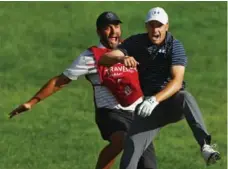  ?? MADDIE MEYER/GETTY IMAGES ?? Jordan Spieth celebrates with caddy Michael Greller after making birdie from a bunker to win the Travelers Championsh­ip in a playoff on Sunday.