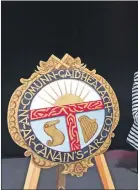  ??  ?? Above: Mairi MacColl presents the Charlie MacColl Memorial Shield to Sean MacLellan, Ardnamurch­an High School, for attaining the highest mark in conversati­on competitio­ns, fluent and learners.