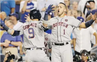  ?? MATT SLOCUM, THE ASSOCIATED PRESS ?? Astros teammates Marwin Gonzalez, left, and Carlos Correa celebrate a home run during the ninth inning of Game 2 against the Dodgers in Los Angeles.
