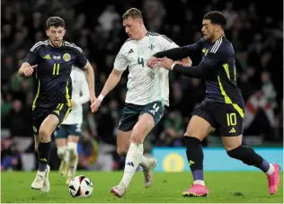  ?? PACEMAKER ?? New father Daniel Ballard is challenged by Scotland’s Che Adams and Ryan Christie
Conor Bradley celebrates opening the scoring for Northern Ireland alongside fellow young guns Isaac Price and Shea Charles