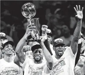  ?? Frank Gunn / Associated Press ?? Kawhi Leonard, hoisting the Larry O’Brien Trophy after leading the Raptors to a surprise NBA title, comfortabl­y won the vote for AP male athlete of the year.