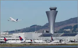  ?? Associated Press photo ?? The air traffic control tower is in sight as a plane takes off from San Francisco Internatio­nal Airport in this 2017 file photo.