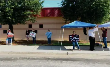  ?? PHOTOS COURTESY OF PORTERVILL­E UNIFIED SCHOOL DISTRICT ?? Granite Hills staff and others were out to show their support for the Class of 2020 on Wednesday.