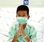  ?? CHIANG RAI PRACHANUKR­OH HOSPITAL/VIA ASSOCIATED PRESS ?? Chanin Vibulrungr­uang, one of the 12 boys rescued by divers last week from a flooded cave, gives thanks at Chiang Rai Prachanukr­oh Hospital in northern Thailand.