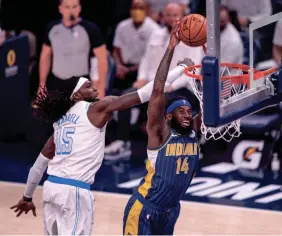  ?? DOUG MCSCHOOLER/AP ?? Pacers forward JaKarr Sampson (14) scores while Lakers center Montrezl Harrell (15) defends during the second half in Indianapol­is on Saturday.