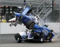  ?? MARTY SEPPALA — THE ASSOCIATED PRESS ?? The car driven by Scott Dixon goes over the top of Jay Howard in the first turn during the Indianapol­is 500. Dixon was the pole sitter, and was unhurt in the crash.