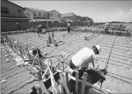  ?? Mark Boster Los Angeles Times ?? WORKERS FRAME and prepare the foundation forms Tuesday for a Shea Homes project at the Pavilion Park developmen­t in Irvine.