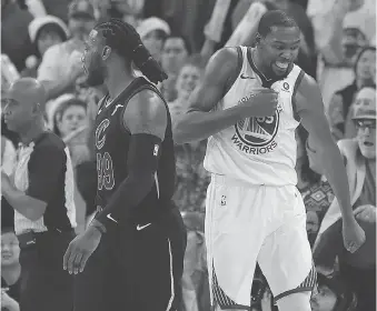  ?? TONY AVELAR/THE ASSOCIATED PRESS ?? Warriors forward Kevin Durant, right, blocked a key late shot by LeBron James and celebrated in front of Cleveland’s Jae Crowder during Golden State’s victory Monday in Oakland.