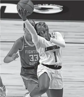  ?? ERIC GAY/AP ?? Louisville guard Dana Evans drives to the basket past Oregon guard Sydney Parrish in a Sweet 16 game on Sunday in San Antonio.