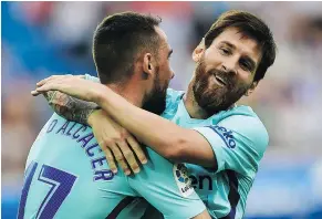  ?? — THE ASSOCIATED PRESS ?? Barcelona’s Lionel Messi, right, celebrates his second goal of Saturday’s 2-0 Barcelona win over Deportivo Alaves with teammate Paco Alcacer in Spanish League play Saturday.