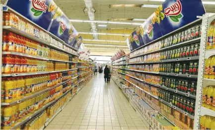  ?? (Zohra Bensemra/Reuters) ?? SHOPPERS ARE seen at the Ardis supermarke­t in Algiers last year. At the start of this year, authoritie­s banned the import of 851 products, including foodstuffs and some raw materials, in a bid to address a gaping trade deficit that widened as energy...