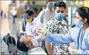  ??  ?? A health worker collects swab samples from a passenger at the Chhatrapat­i Shivaji Maharaj Terminus on Friday.