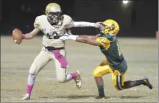  ??  ?? Vincent Memorial High’s quarterbac­k Eduardo Valenzuela stiff arms a Holtville High defender he runs up the field. EDWIN DELGADO PHOTO