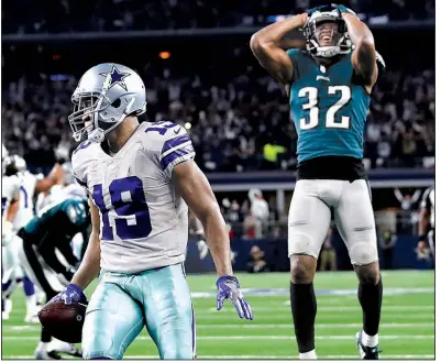  ?? AP/ROGER STEINMAN ?? Dallas wide receiver Amari Cooper scores in overtime as Rasul Douglas of the Philadelph­ia Eagles watches, giving the Cowboys a 29-23 victory Sunday in Arlington, Texas. Cooper finished with 10 catches for 217 yards and 3 touchdowns in his second game in the past three with at least 180 yards and 2 scores.