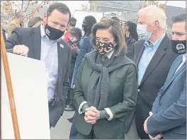  ?? PHOTOS BY ARIEL CARMONA- LAKE COUNTY PUBLISHING ?? Speaker of the House Nancy Pelosi (D-san Francisco), flanked by local and state legislator­s, surveys a poster board showing the recovery of the Coffey Park area prior to a press conference on infrastruc­ture and wildfire resiliency held Saturday in Santa Rosa.