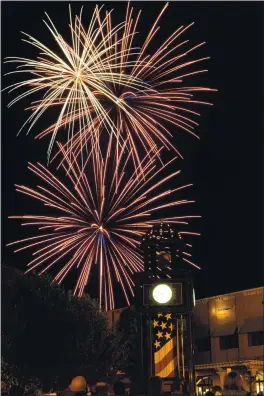  ?? JOEL ROSENBAUM — REPORTER FILE PHOTO ?? Fireworks explode in the night’s sky over the clock tower in the Town Square during the 2012 Fourth of July Celebratio­n. The event, along with the CreekWalk concert series, was canceled last year due to concerns over the coronaviru­s, but the council unanimousl­y voted Tuesday to hold both events this year with modificati­ons.