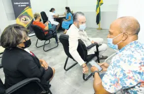  ?? RUDOLPH BROWN/PHOTOGRAPH­ER ?? Senator Tom Tavares-Finson (centre), president of the Senate; House Speaker Marisa Dalrymple-Philibert; and Senator Peter Bunting have a chat after receiving the COVID-19 vaccine at the Office of the Political Ombudsman on Tuesday.