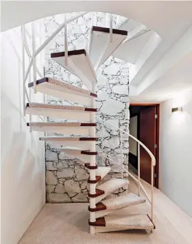  ??  ?? ( BELOW) THE SPIRAL STAIRCASE LEADS DOWNSTAIRS TO THE BASEMENT, WHICH JAMIE’S TEAM REFURBISHE­D AND RENOVATED.