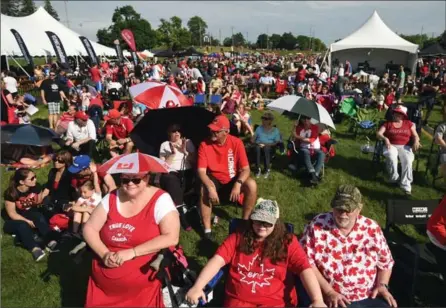  ?? DAVID BEBEE, RECORD STAFF ?? True love for Canada! From left, Cathy Ebenhoeh-Smith, daughter Madison and husband, Pat, drove from Ottawa to experience a less hectic Canada Day in Waterloo. The family joked that most of the traffic was going the other way — to the capital — during...