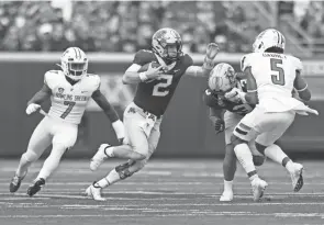  ?? STACY BENGS/AP ?? Minnesota quarterbac­k Tanner Morgan scrambles against Bowling Green on Saturday. Morgan went 5 of 13 for 59 yards with four sacks and two intercepti­ons in a stunning 14-10 home loss.