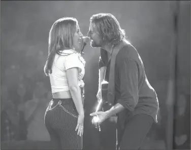  ?? Clay Enos/AP ?? Movie: This image released by Warner Bros. Pictures shows Lady Gaga, left, and Bradley Cooper in a scene from "A Star is Born."