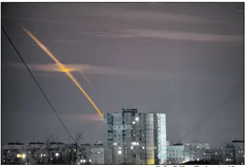  ?? Vadim Belikov The Associated Press ?? Russian rockets launched against Ukraine from Russia’s Belgorod region streak across the sky at dawn Friday in Kharkiv, Ukraine.