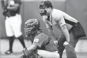  ?? The Hartford Courant/tns ?? Plate umpire Jorge Teran watches play between the New Britain Bees and the Southern Maryland Blue Crabs at New Britain Stadium Thursday. The Atlantic League is partnering with Major League Baseball in its experiment­ation of several new rules.